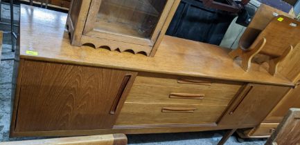 A mid century Nathan retro sideboard, three graduated central drawers flanked by twin sliding