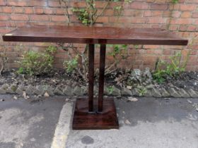 A modern oak finished console table supported by two central pillars, on a plinth Location: