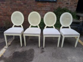 A set of four late 20th century cream painted dining chairs with caned backs, Location: