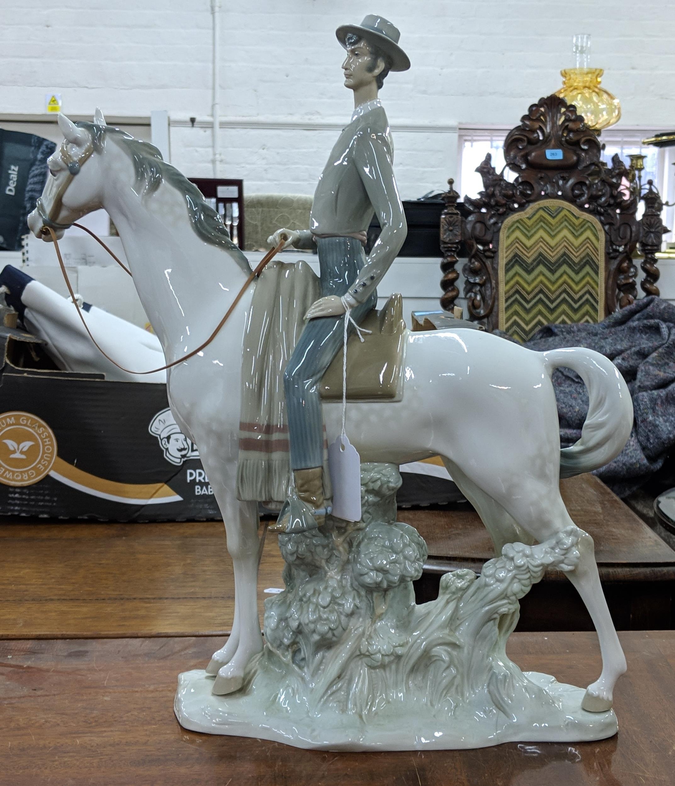 A Lladro figure of an elegant man in smart dress on horseback, Location: