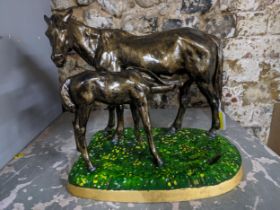 A painted and lacquered cast iron model of a horse and foal, dated 1967 with cast marks to the