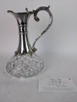 An Elizabeth II silver and cut glass claret jug decorated with two ridged neck rings, lower border