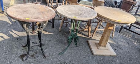 Two Victorian pub tables with cast iron legs A/F, together with a pine circular topped occasional