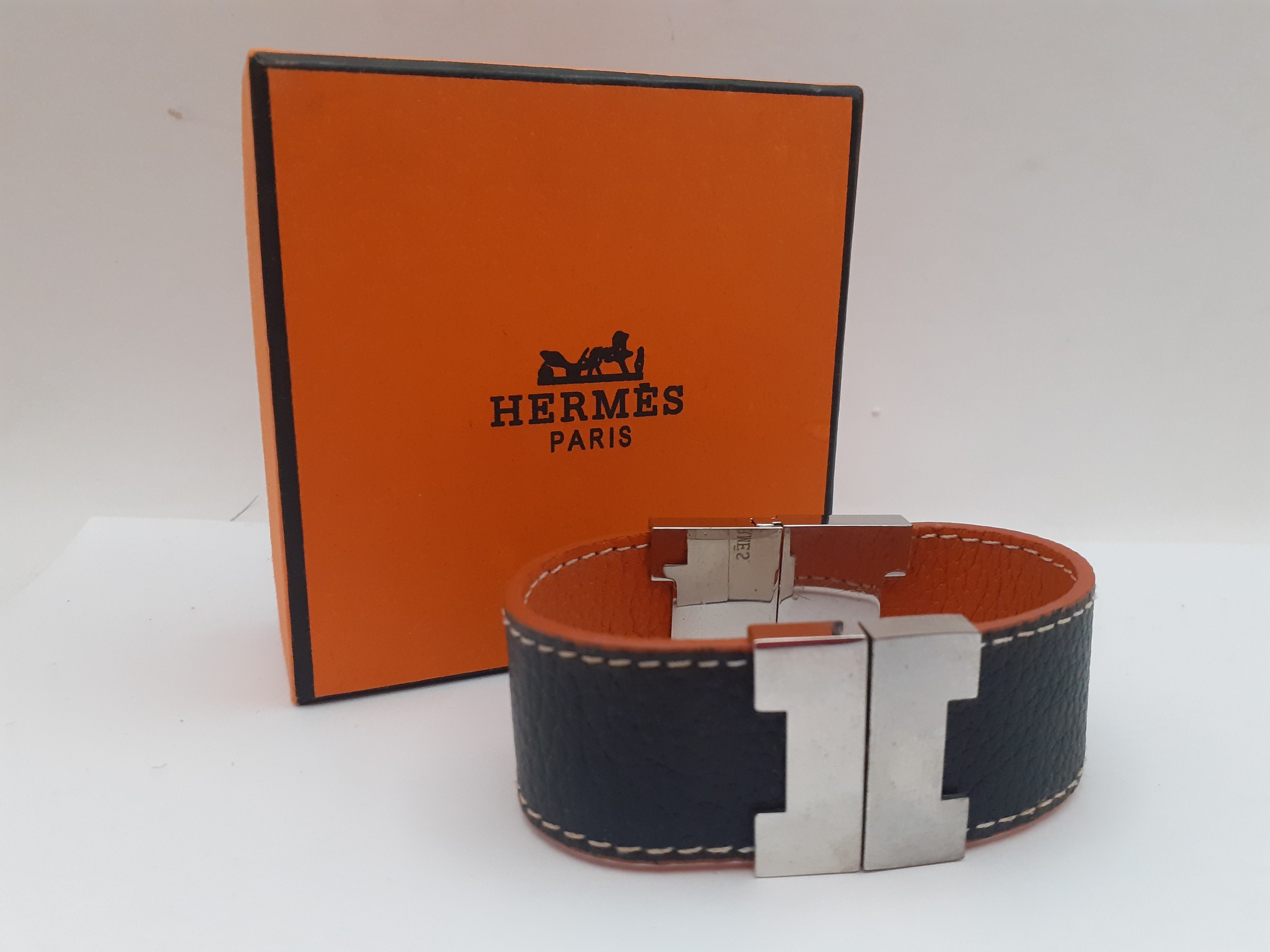 Hermes-A reversible brown and orange leather 'Leurie' wrist strap having silver tone hardware,