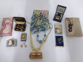 A selection of costume jewellery to include a Victorian shell cameo profile brooch in a 9ct gold