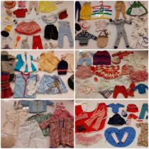 A quantity of vintage dolls clothing to include Sindy horse riding clothing, horse blanket and