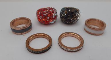 Six modern fashion rings comprising 2 Thomas Sabo gold tone and crystal bands and 4 Swarovski gold