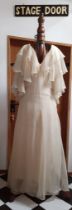 Frank Usher-A 1970's cream chiffon full length evening gown having tiered waterfall sleeves, 32/