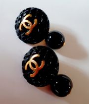 Chanel- A pair of 1994 Autumn collection black Matrasse Coco cufflinks with gold tone interlocking