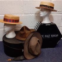 A group of four 20th Century hats comprising 2 straw boaters and 2 wide brim brown felt hats to