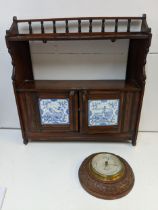 A late 19th century mahogany shelf with twin tiled doors, and a carved barometer Negretti & Zambra