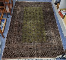 A Pakistani hand woven rung having a green ground with elephant foot motifs and bearing signature,