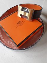 Hermes- A brand new gents Togo grain reversible noir/orange leather belt having a brushed gold