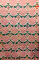 A late 20th Century American Mid West double layer handmade patchwork quilt in a diamond shaped