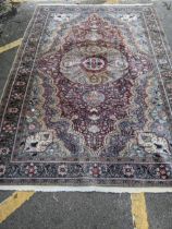A Turkish hand woven woollen carpet, central floral medallion surrounded by all over floral designs,