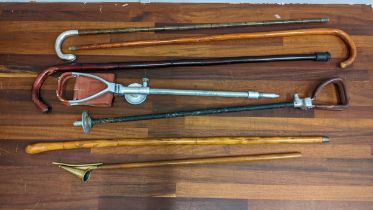 Walking sticks to include one with a silver crook handle, shooting sticks and an ecclesiastical