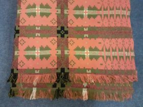 A vintage pink, green, black and white Welsh wool blanket with geometric design having a fringe to 2