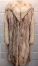 A late 20th Century arctic fox coat with brown tinge having a shawl collar having a blue lining,