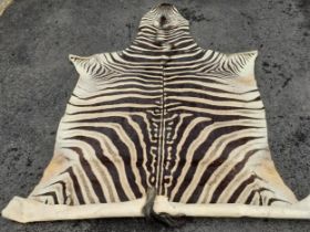 A large vintage zebra hide A/F, approx 105" long. Location:RWB Condition: Some stiffness and tears-