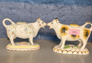 A late 19th/early 20th century Staffordshire cow creamer together with a late 20th century creamer