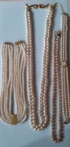 Four simulated pearl necklaces to include a Le Bijou 2 strand necklace with gold tone and white