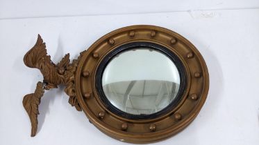 A 19th century carved giltwood mirror with a convex plate surmounted by an eagle, 65cm h A/F