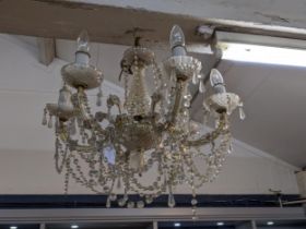 A pair of glass and brass effect six branch chandeliers with fluted pendant drop and swag