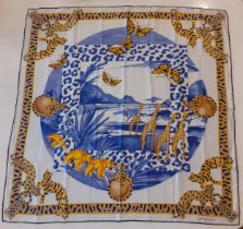 Cartier-A silk African Savanna scarf having a pale grey ground and a border with images of jewel