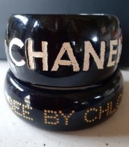 Jessica Kagan Cushman and Chloe-A small 'Ripped Off By Chanel' black bangle with cream