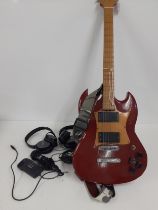 A Gibson SG clone with an after-market replacement neck in red with a wooden pick guard together