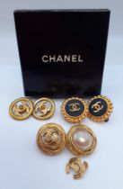 Chanel- Three pairs of Chanel gold tone clip-on earrings to include a pair of Autumn 1993 black wood