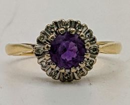 An 18ct gold ring set with a central amethyst, surrounded by diamonds, size N, 3.7g Location: