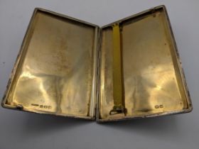 A George V silver cigarette case, machine tooled decoration, gilt interior sliding mechanism to