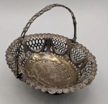 A silver pedestal basket having pierced boarders and a floral embossed rim hallmarked London 1774,