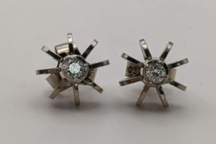 A pair of white metal and diamond earrings, one back stamped 750, the other stamped 9ct, 2.2g