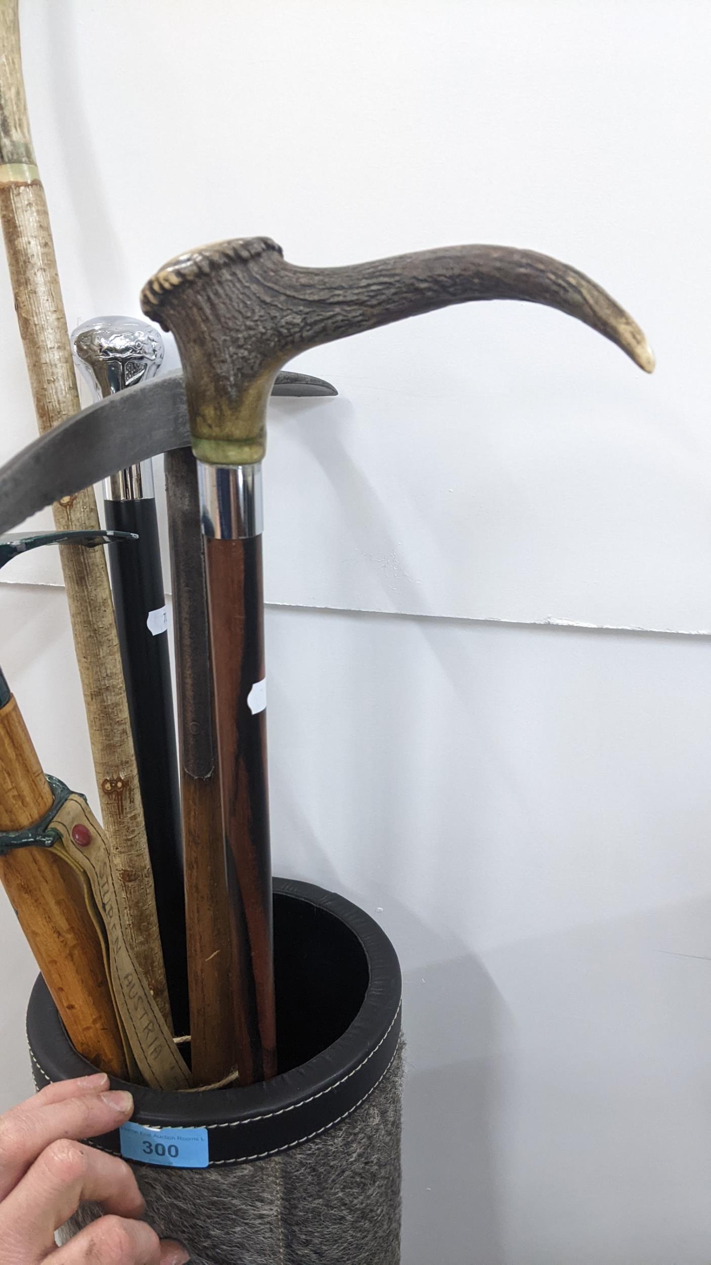 A fur and leather stick stand containing walking sticks and pick axes to include a horn handled - Image 4 of 4