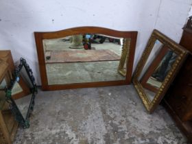 A group of five wall mirrors to include a mahogany framed mirror with arched top, bevelled glass