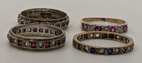 Four 9ct gold rings, one a full eternity, one stone missing, and the other set with rubies and