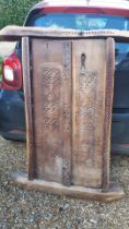 An Omani village house door, heavily decorated in two panels with four supporting beams, Location: