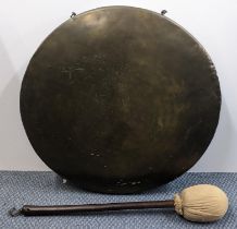 A wall hanging brass gong with striker Location: