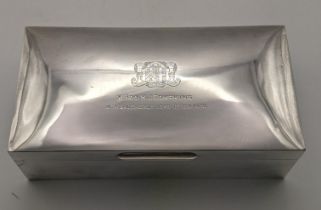 A silver cigarette box hallmarked London 1928 having an engraved inscription to the lid, W Bro H J