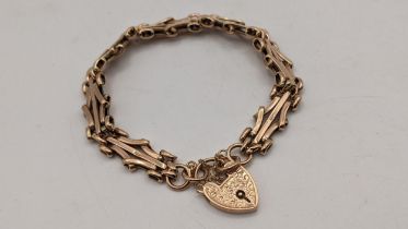 A 9ct gold bracelet with a floral engraved heart shaped gold locket, 13.6 grams