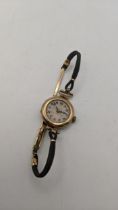 A 9ct gold ladies manual wind wristwatch A/F, on a fabric bracelet and a clasp total