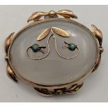 A Victorian 9ct gold brooch set with a turquoise on an agate coloured back Location: