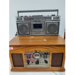 A reproduction music centre in veneered case together with a Sanyo portable tape and radio player,