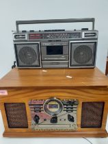 A reproduction music centre in veneered case together with a Sanyo portable tape and radio player,