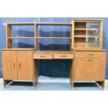 A 1960s light elm desk, having a glazed section with two sliding doors and open shelves, above