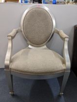 A modern silver painted bedroom chair with upholstered seat, backs and arms in a beige fabric on