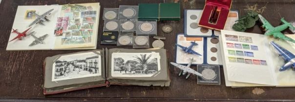 A mixed lot to include vintage Dinky airplane models British coins and postage stamps to include