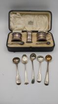 A boxed set of silver pierced condiments, together with four various silver salts, spoons and a